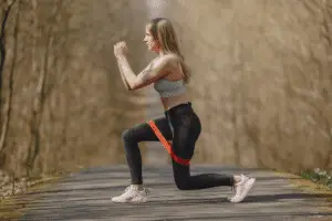 Woman doing resistance band lunges – effective workout for weight loss tips for women over 30